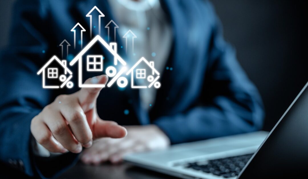 A person points at icons floating above a laptop. The icons include houses, percentage symbols, and upward arrows.