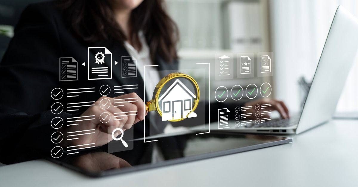 A person uses a laptop. Digital icons appear above the laptop, including a house with a magnifying glass over it.