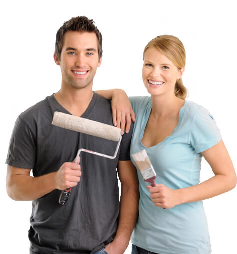 Couple with paint brush and roller ready to remodel home