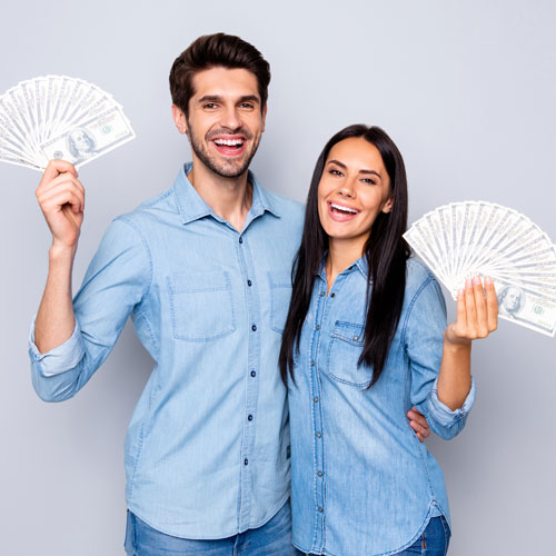 Man and women holding up thousands of dollars